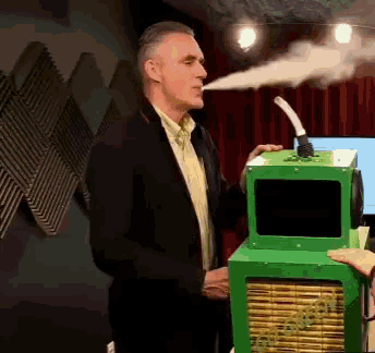 a man in a black suit is smoking a cigarette