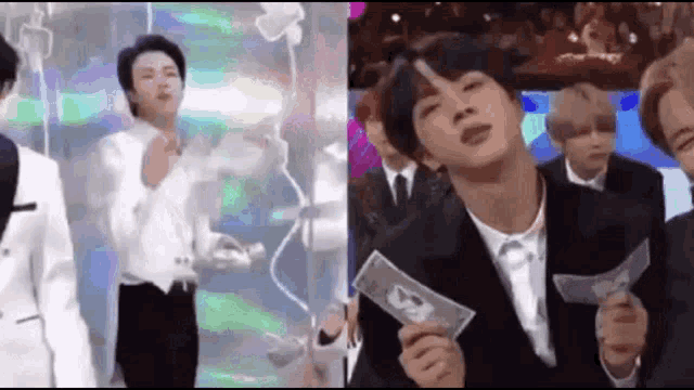 a man in a suit and tie is holding a bunch of money .