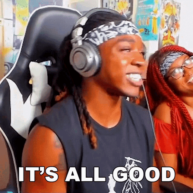 a man wearing headphones says it 's all good while sitting in a gaming chair
