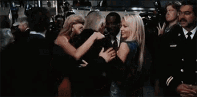 a man and a woman are hugging each other in a crowd