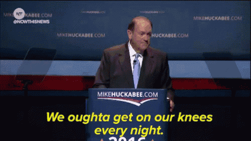 a man stands behind a podium that says mikehuckabee.com