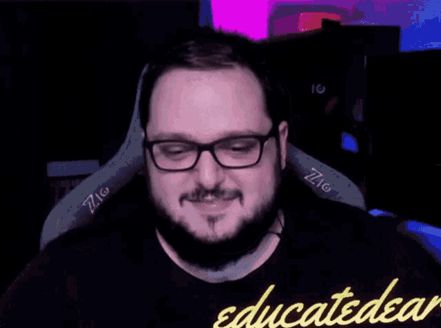 a man with glasses and a beard is making a funny face with his hands in the air .