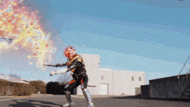 a man in a superhero costume is standing in front of a building with flames coming out of his head