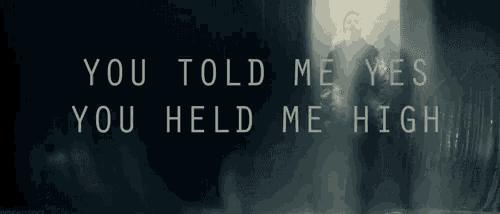 a man stands in a dark room with the words you told me yes you held me high