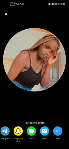a woman in a black tank top is in a circle on a phone