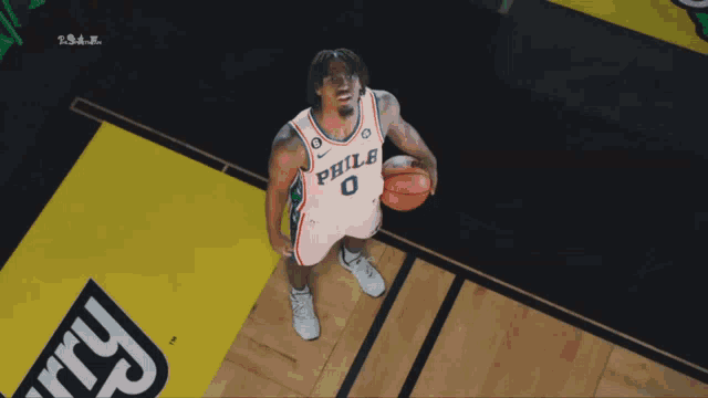 a philadelphia basketball player holding a basketball