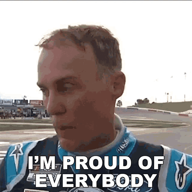 a man in a race car jacket says i 'm proud of everybody .