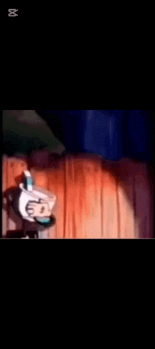 a close up of a cartoon character 's mouth with the letters m on the bottom