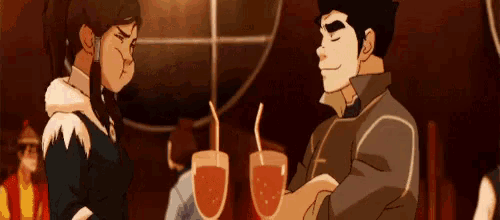 a man and a woman are standing next to each other drinking from glasses .