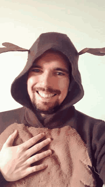 a man wearing a reindeer costume with antlers
