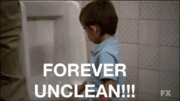 a young boy is standing in front of a urinal and says forever unclean