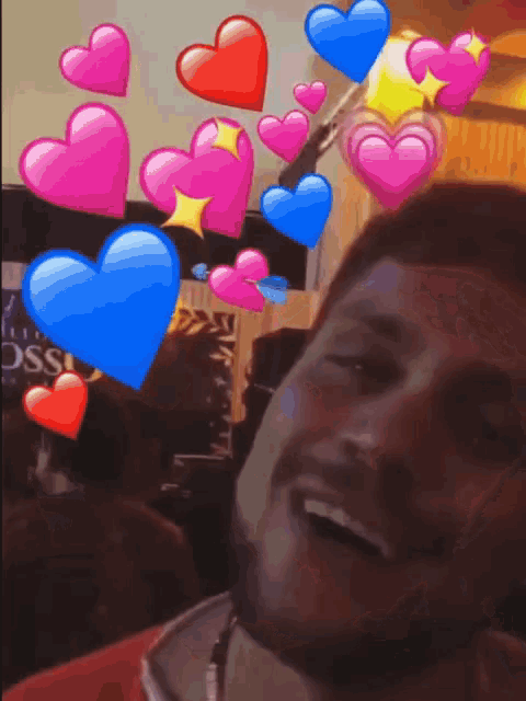 a man 's face is surrounded by pink and blue hearts and a sign that says oss