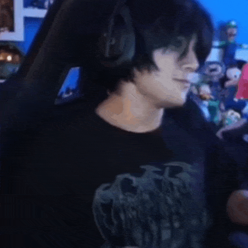 a man wearing headphones and a black shirt is dancing in a video game .