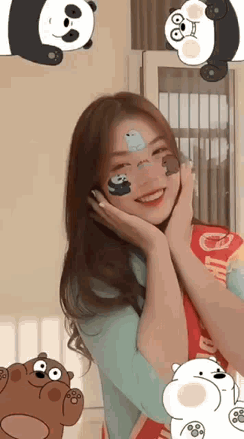 a girl with pandas and bears on her face is smiling