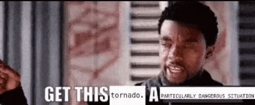 a man is standing in front of a window with the words `` get this tornado a particularly dangerous situation ''