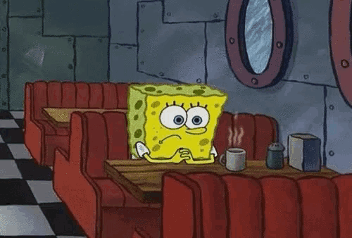 spongebob squarepants is sitting at a table in a diner .