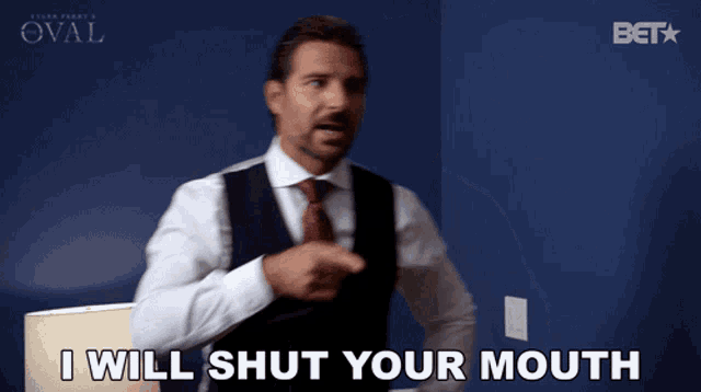 a man says " i will shut your mouth " in front of a blue wall