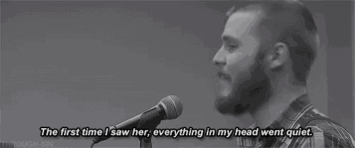 a man with a beard is singing into a microphone in a black and white photo with a quote .