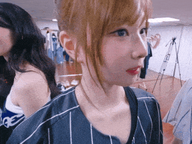 a girl wearing a striped shirt with the letter g on the front