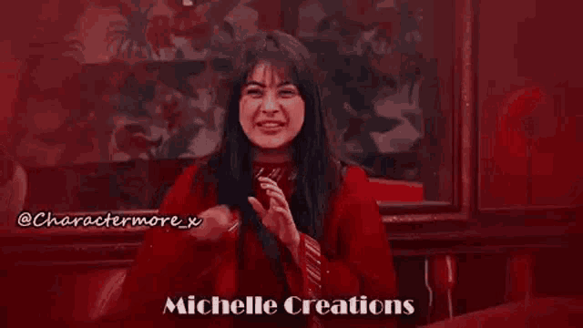 a woman in a red dress is laughing and smiling while sitting in a chair .