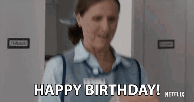 a woman in a blue apron says " happy birthday netflix "