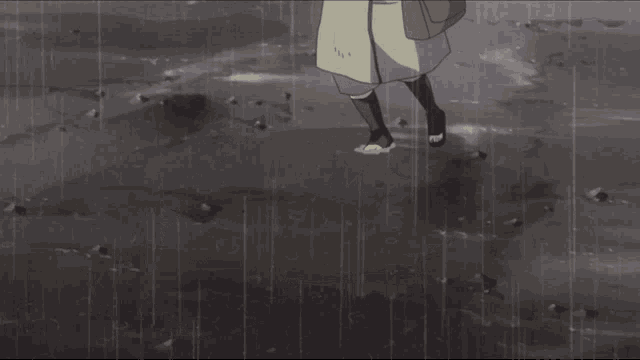 a person laying on the ground in the rain with a backpack on