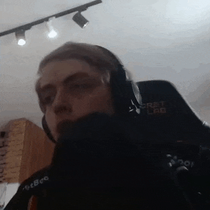 a man wearing headphones is sitting in a chair in a room .