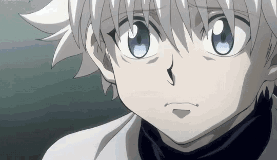 a close up of a boy with white hair and blue eyes .