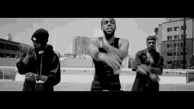 a group of men are dancing in front of a city skyline