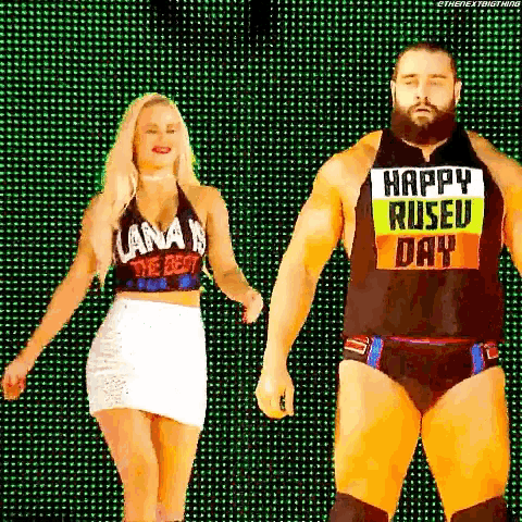 a man and a woman are standing next to each other on a stage holding hands .