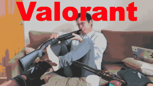 a man sits on a couch holding a shotgun with the word valorant in red