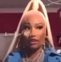 a close up of a woman 's face with a ponytail and a blue jacket .