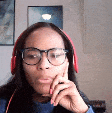 a woman wearing glasses and red headphones looks at the camera .