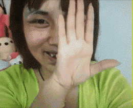 a woman is covering her face with her hand
