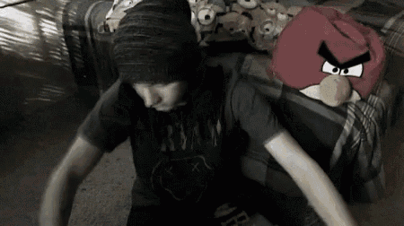 a boy wearing a nirvana shirt is sitting on a couch