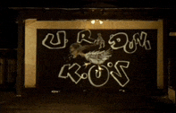 a sign that says ' urdom ros ' on it with a bird on it