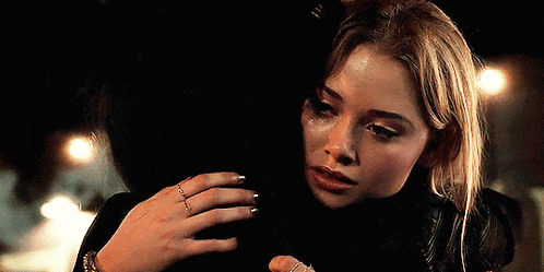 a woman is hugging another woman with a ring on her finger