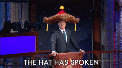 Stephen Colbert Big Furry Hat GIF - Stephen Colbert Big Furry Hat The Hat Has Spoken GIFs