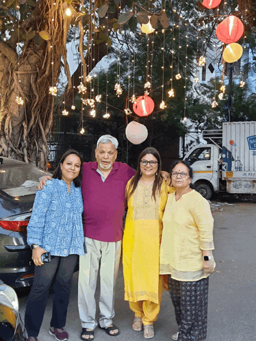 a group of people posing for a picture in front of a white truck that says ' a ' on the side