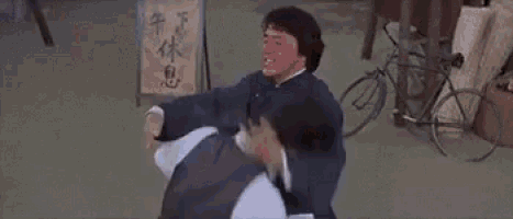 a man is flying through the air while another man is walking in the street .