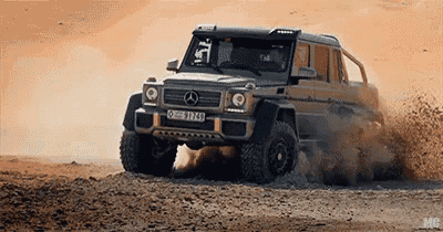 a mercedes g63 6x6 is driving through the desert