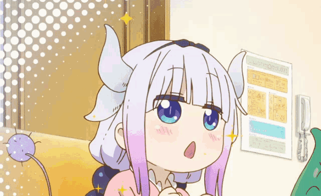 a girl with horns is sitting in front of a wall with a sign on it