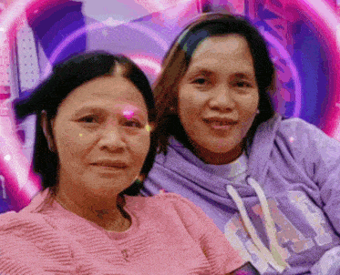 two women are posing for a picture with one wearing a purple gap sweatshirt