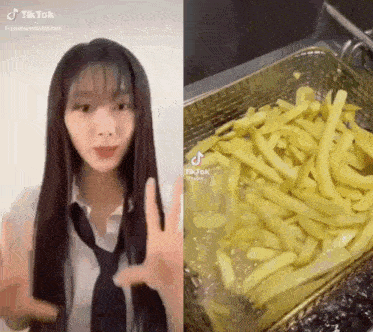 a woman in a tie is standing next to a basket of french fries in a fryer .
