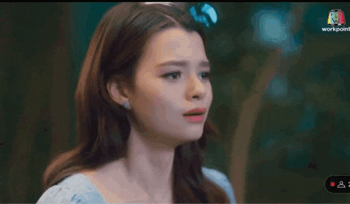 a woman in a blue dress is crying with a tear coming out of her eye
