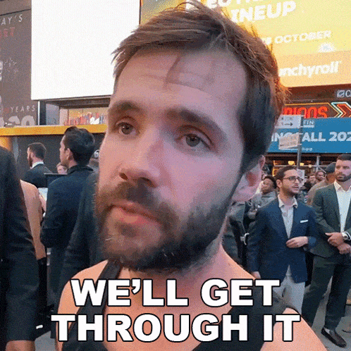 a man with a beard says we 'll get through it in front of a crowd