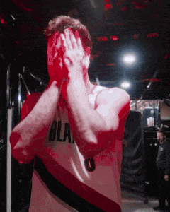a man in a bla jersey covering his face