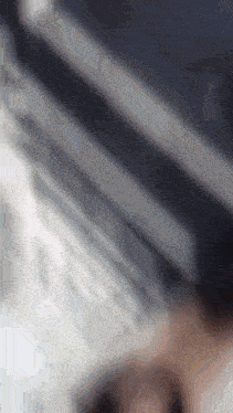 a blurry image of a person using a laptop