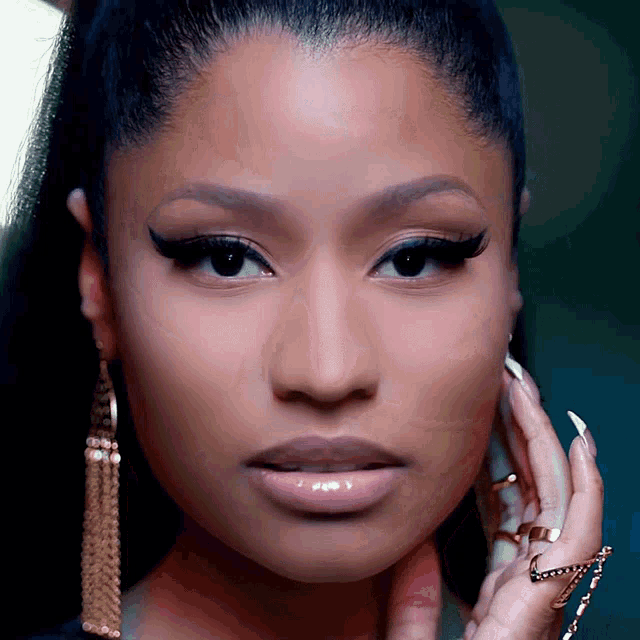 a close up of a woman 's face wearing earrings