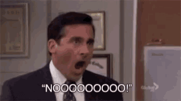 a man in a suit and tie is making a surprised face and saying `` nooooo ! ''